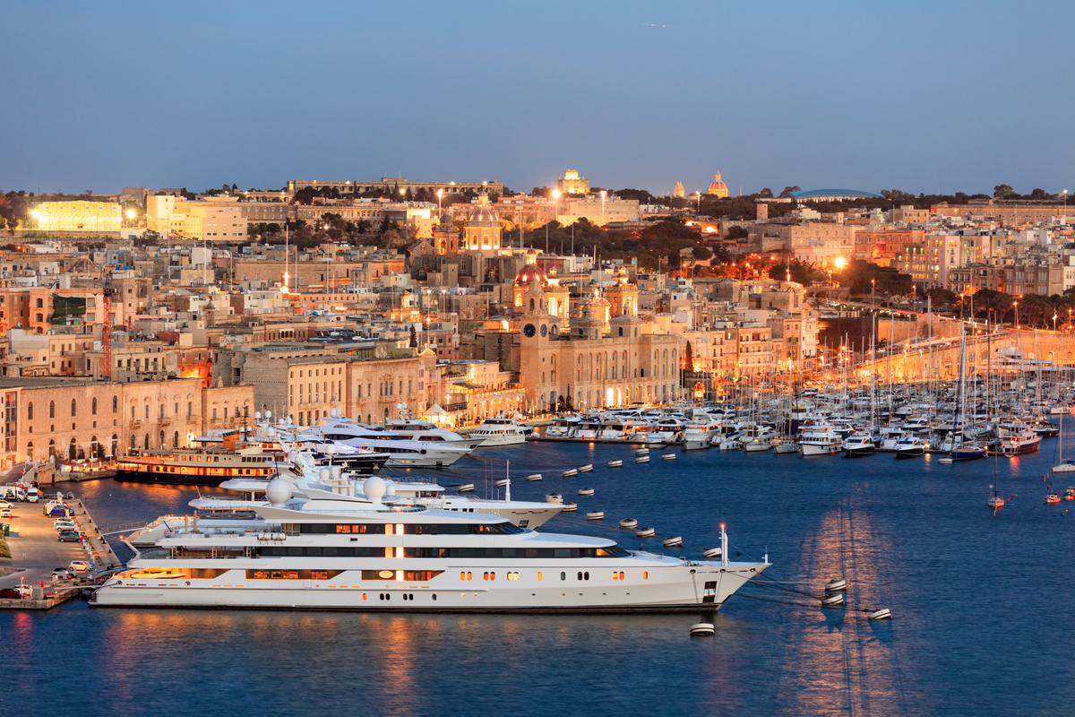 Superyachts moored in Malta's Grand Harbour at dusk